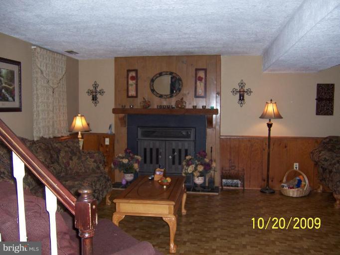 9417 Gunview Road Nottingham, MD 21236 - Photo 21 of 30 a living room with furniture and a fireplace