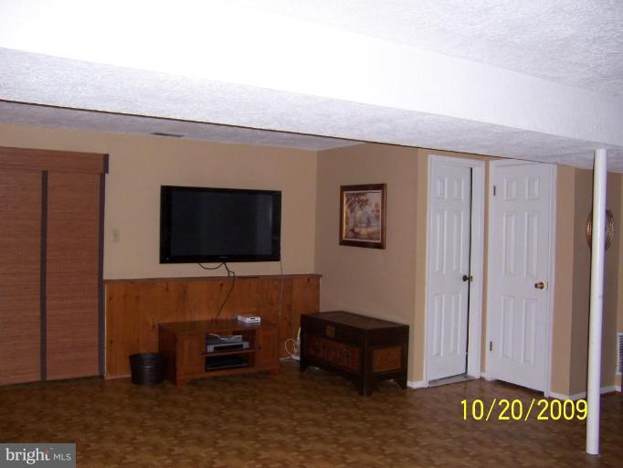 9417 Gunview Road Nottingham, MD 21236 - Photo 22 of 30 a living room with furniture and a flat screen tv