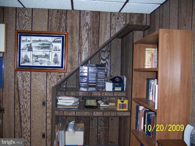 9417 Gunview Road Nottingham, MD 21236 - Photo 23 of 30 a view of staircase with lots of frames on wall and a window