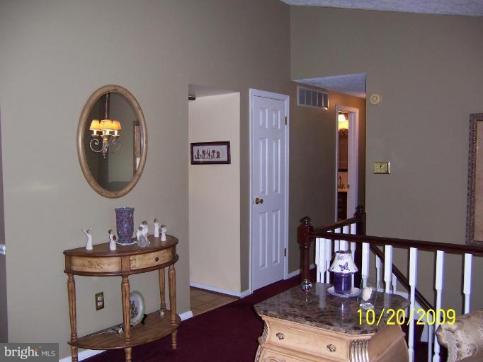 9417 Gunview Road Nottingham, MD 21236 - Photo 4 of 30 a living room with painting on the wall and a wooden floor