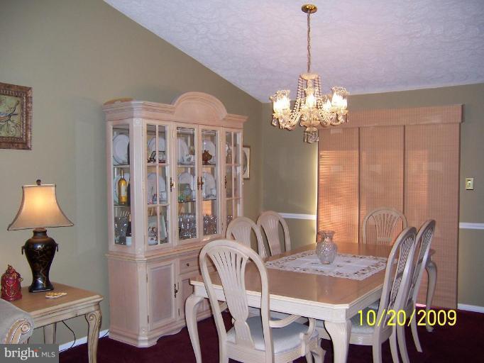 9417 Gunview Road Nottingham, MD 21236 - Photo 5 of 30 a view of a dining room with furniture and chandelier