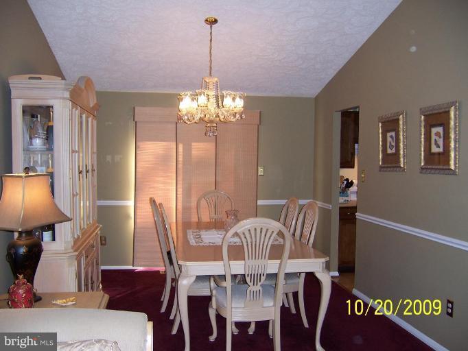 9417 Gunview Road Nottingham, MD 21236 - Photo 6 of 30 a view of a dining room with furniture and chandelier