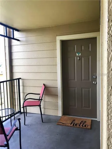 a kitchen with stainless steel appliances kitchen island granite countertop a table chairs and a refrigerator