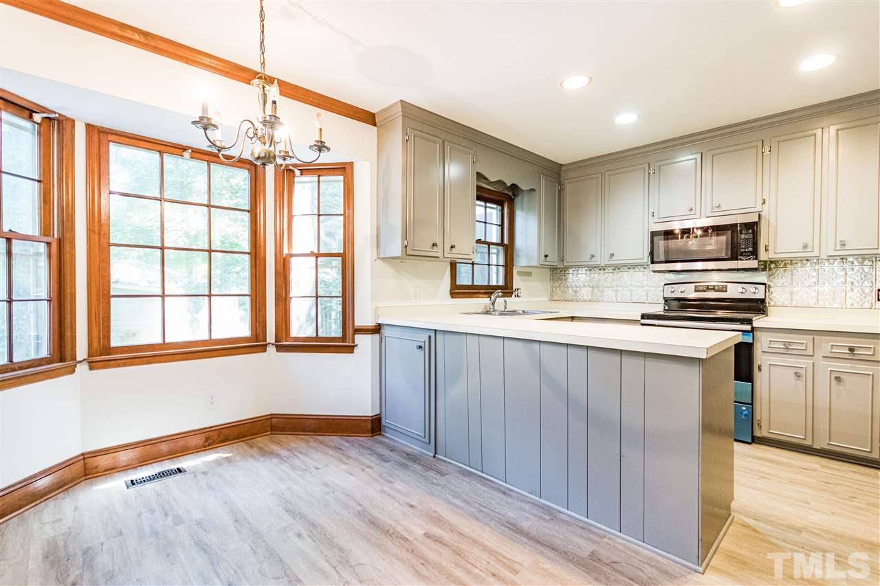 8700 Brandon Station Road Raleigh, NC 27613 - Photo 7 of 23 a kitchen with stainless steel appliances granite countertop a stove a sink and a refrigerator