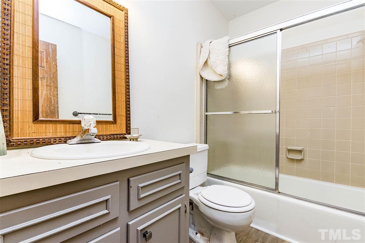 8700 Brandon Station Road Raleigh, NC 27613 - Photo 9 of 23 a bathroom with a sink toilet and shower