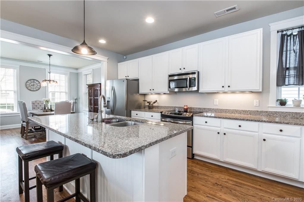 3482 Richard's Crossing Fort Mill, SC 29708 - Photo 4 of 24 a kitchen with stainless steel appliances granite countertop a sink stove and refrigerator