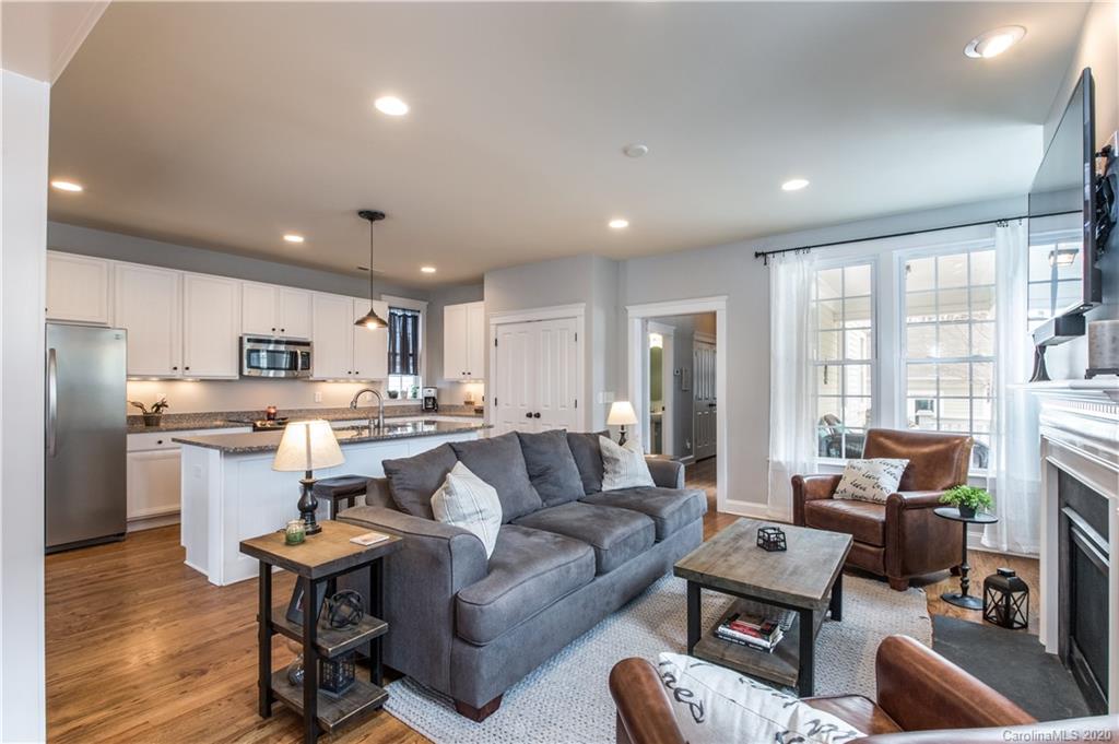 3482 Richard's Crossing Fort Mill, SC 29708 - Photo 10 of 24 a living room with stainless steel appliances granite countertop furniture a couch a fireplace and a view of living room