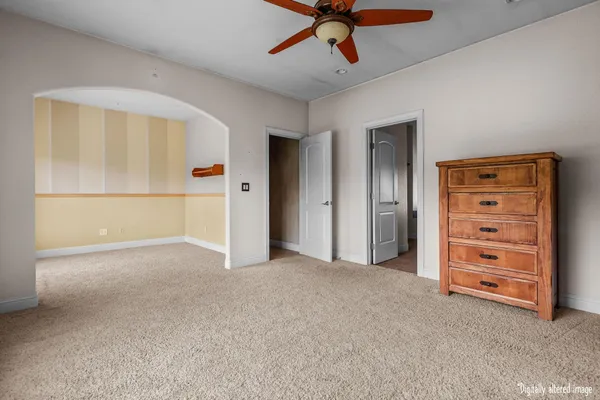 a view of an empty room with a window and a kitchen