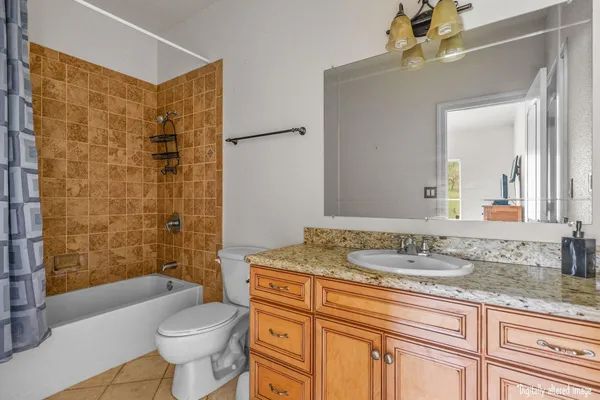 a bathroom with a double vanity sink toilet and shower