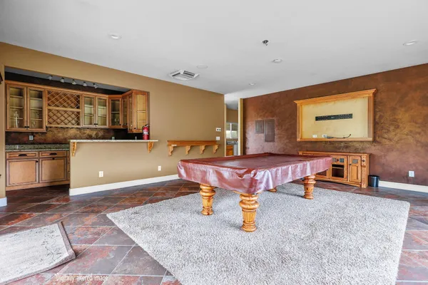 a living room with furniture a flat screen tv and a wooden floor