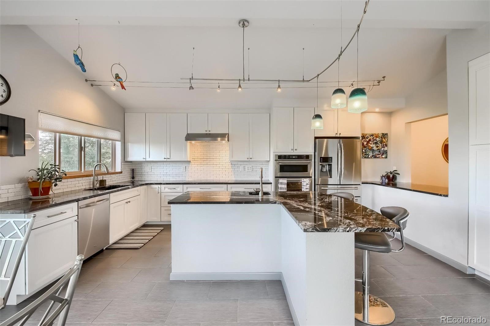 1320 Chambers Drive Boulder, CO 80305 - Photo 13 of 39 a kitchen with kitchen island a counter top space a sink stainless steel appliances and cabinets