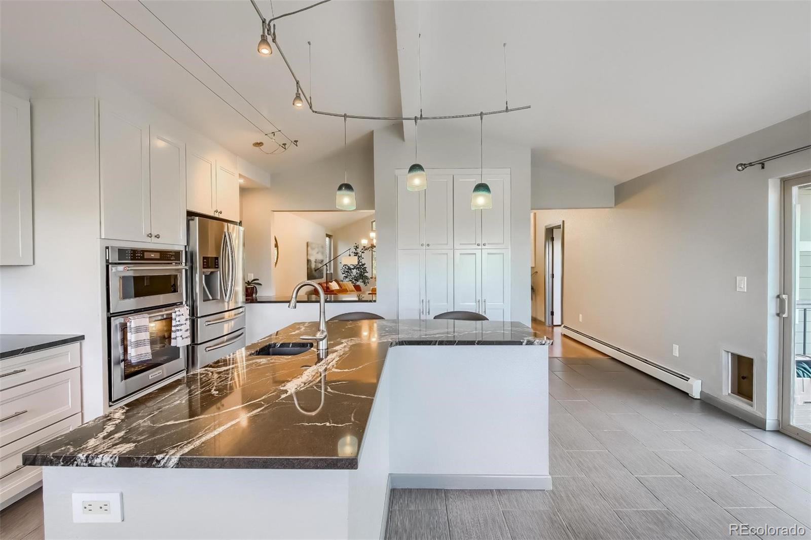1320 Chambers Drive Boulder, CO 80305 - Photo 15 of 39 a kitchen with stainless steel appliances granite countertop a sink stove and refrigerator