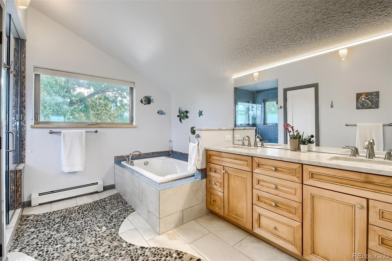 1320 Chambers Drive Boulder, CO 80305 - Photo 20 of 39 a spacious bathroom with a tub sink and mirror