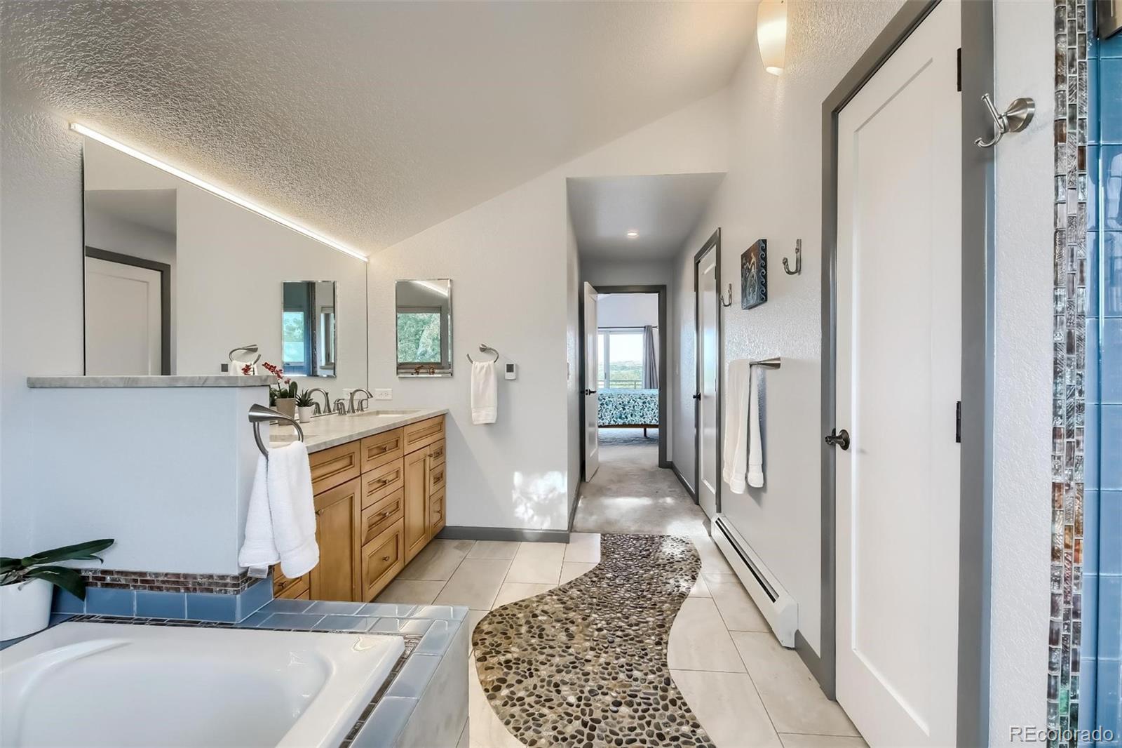 1320 Chambers Drive Boulder, CO 80305 - Photo 21 of 39 a spacious bathroom with a tub sink and mirror
