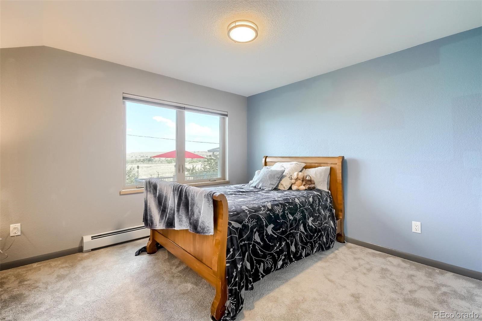 1320 Chambers Drive Boulder, CO 80305 - Photo 23 of 39 a bed sitting in a bedroom next to a window