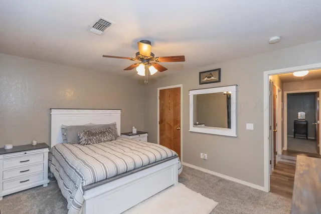 a bedroom with a large bed and a chandelier