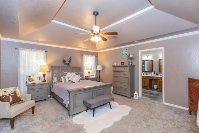 a bedroom with a bed furniture and a ceiling fan