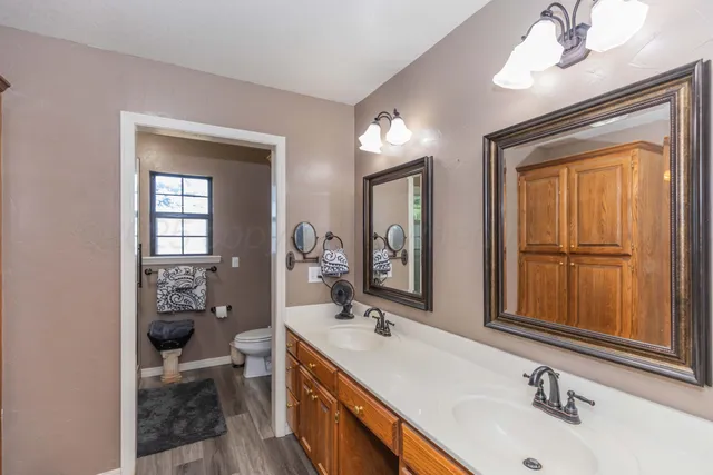 a bathroom with 2 sink and a mirror