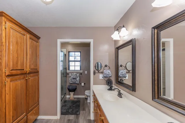 a en suite bathroom with a sink double vanity and shower