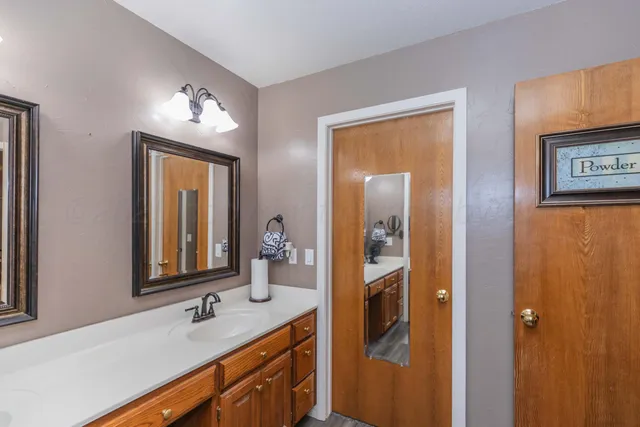 a bathroom with 2 sink and a mirror