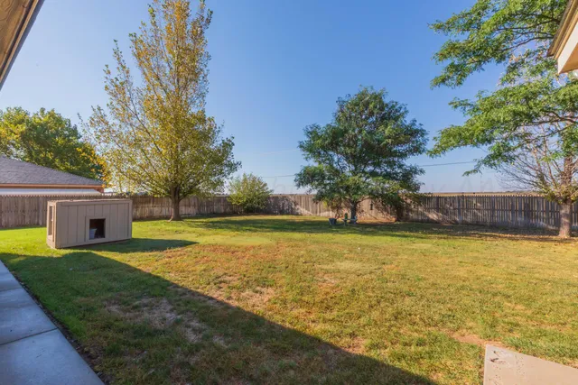 a front view of house with yard and lake