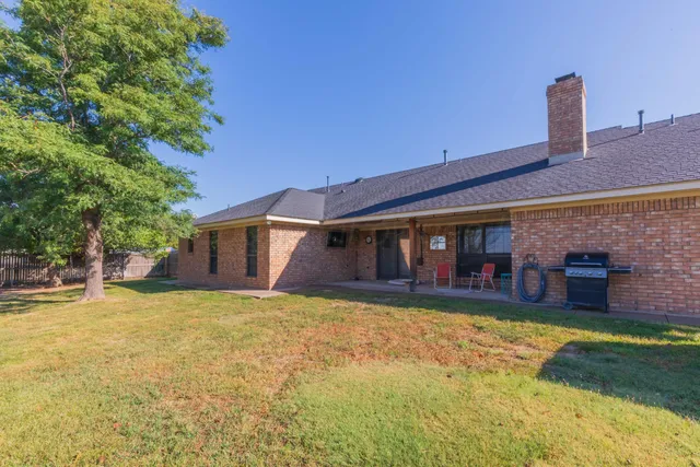 a house view with a sitting space and garden