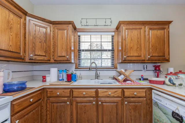 a kitchen with stainless steel appliances wooden cabinets and a sink