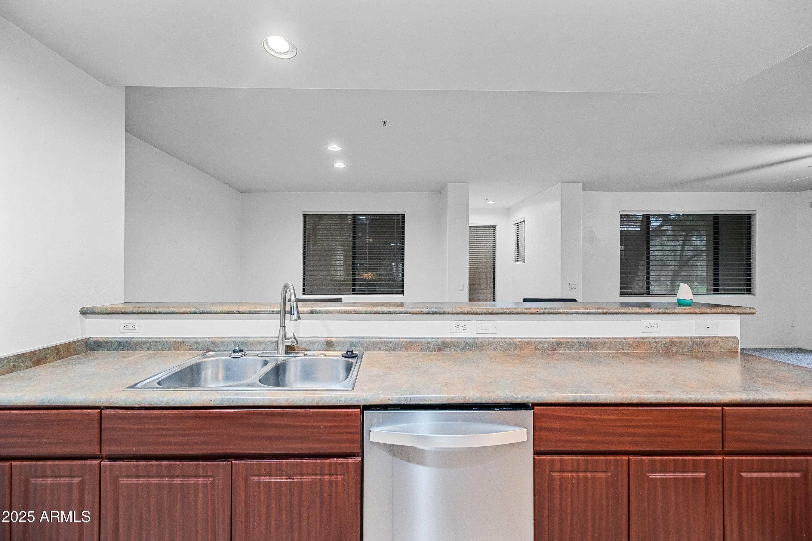 705 West Queen Creek Road, Unit 1079 Chandler, AZ 85248 - Photo 16 of 28 a sink with granite countertop a sink and cabinets