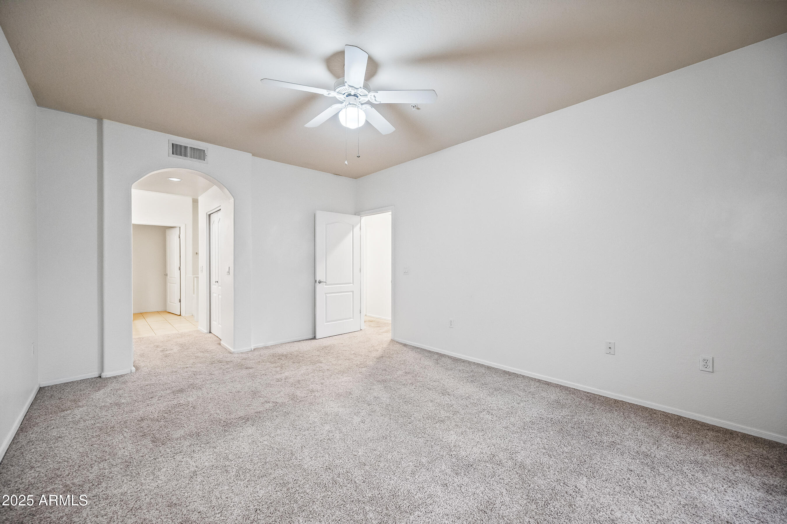 705 West Queen Creek Road, Unit 1079 Chandler, AZ 85248 - Photo 19 of 28 an empty room with chandelier fan and closet area