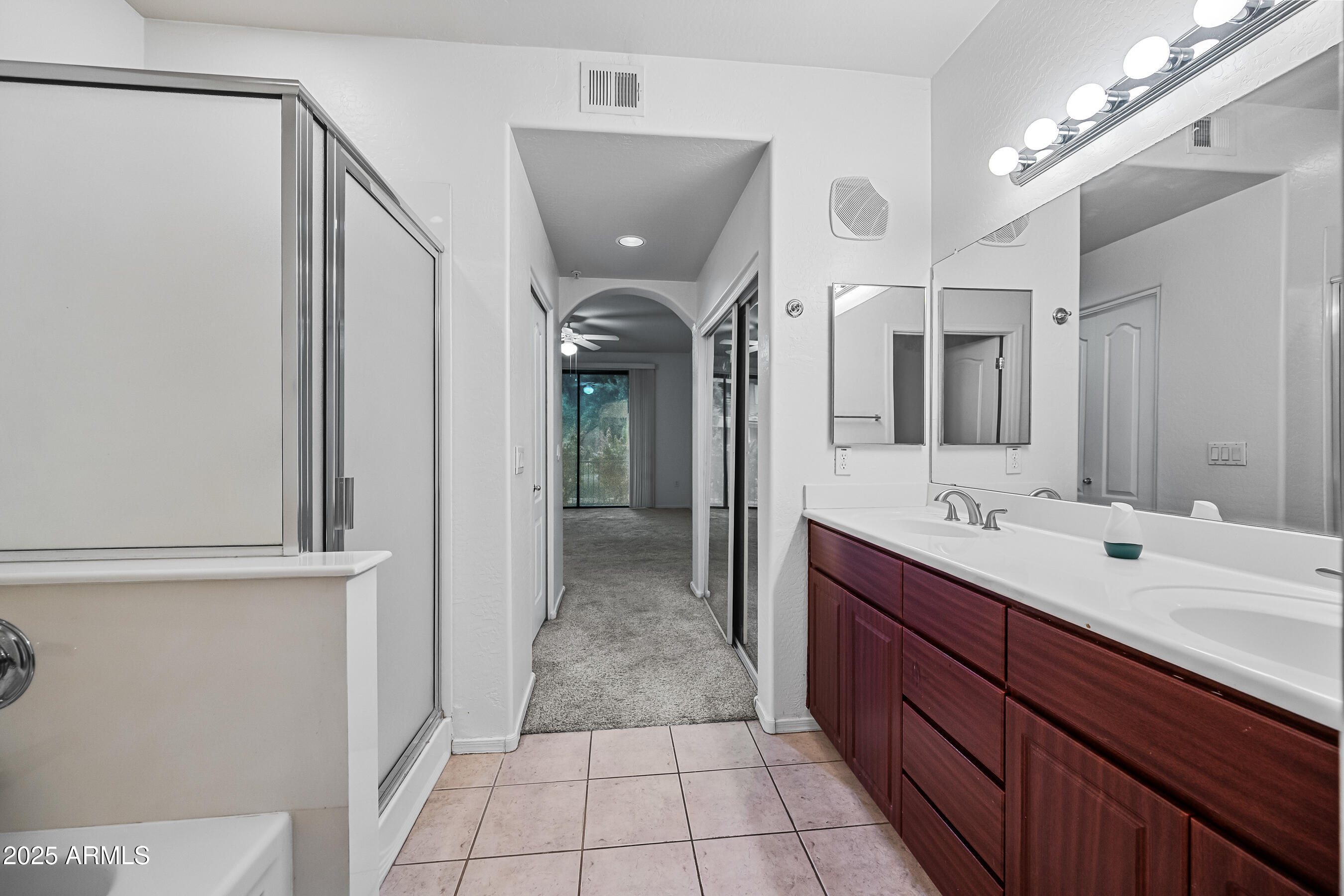 705 West Queen Creek Road, Unit 1079 Chandler, AZ 85248 - Photo 22 of 28 a spacious bathroom with a double vanity sink a mirror and a shower