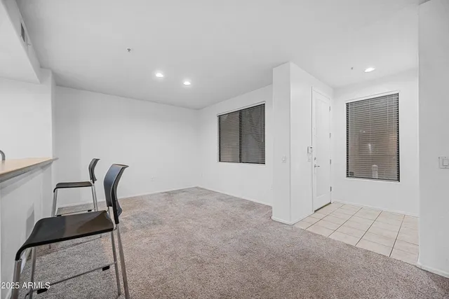 a view of kitchen with stainless steel appliances refrigerator stove microwave and cabinets