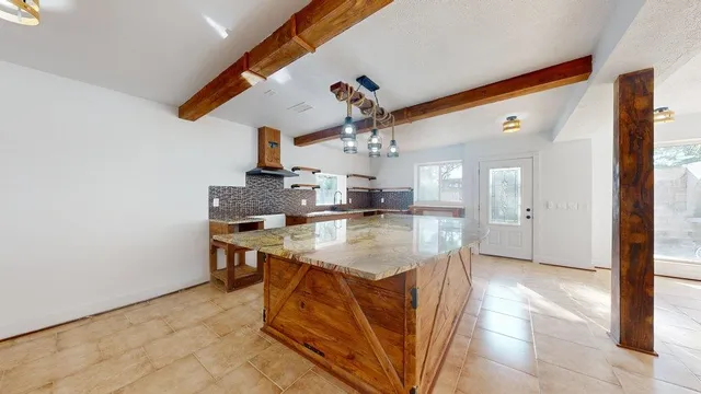 a kitchen with a sink cabinets and wooden floor