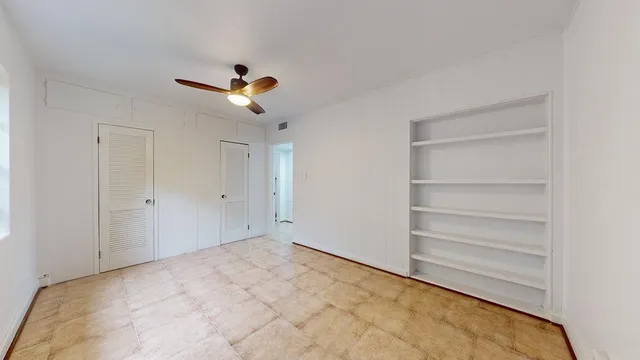 a view of empty room with ceiling fan
