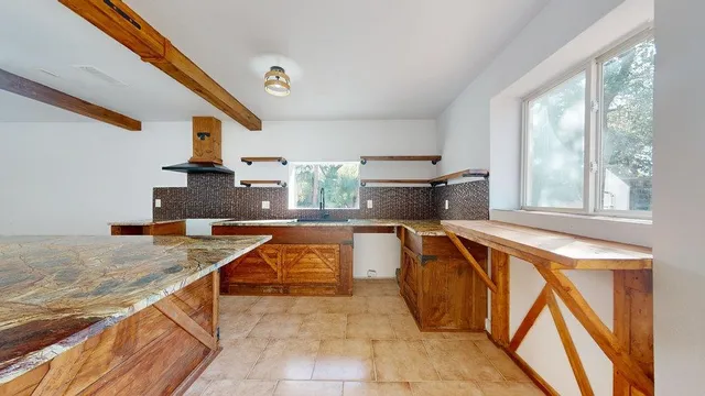 a kitchen with stainless steel appliances granite countertop a sink and a stove