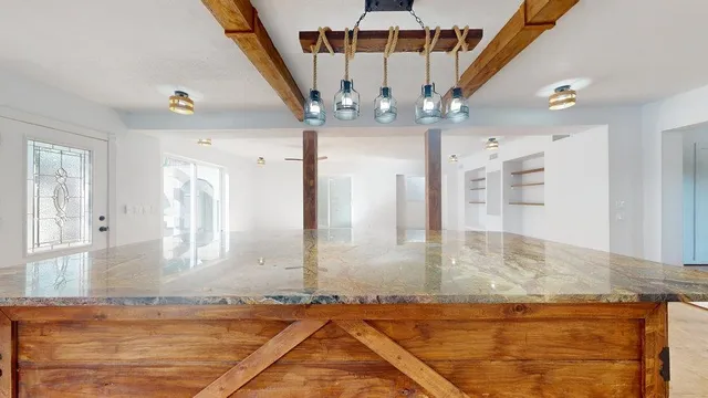 a view of a livingroom with wooden floor and staircase