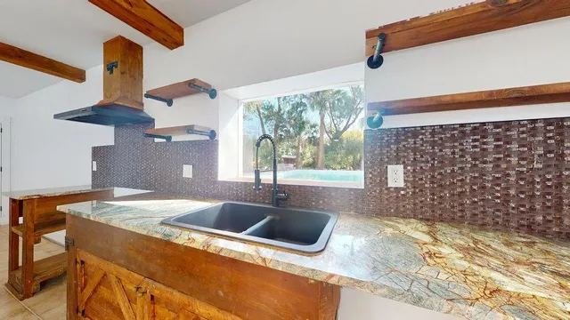 a kitchen that has a sink and a stove
