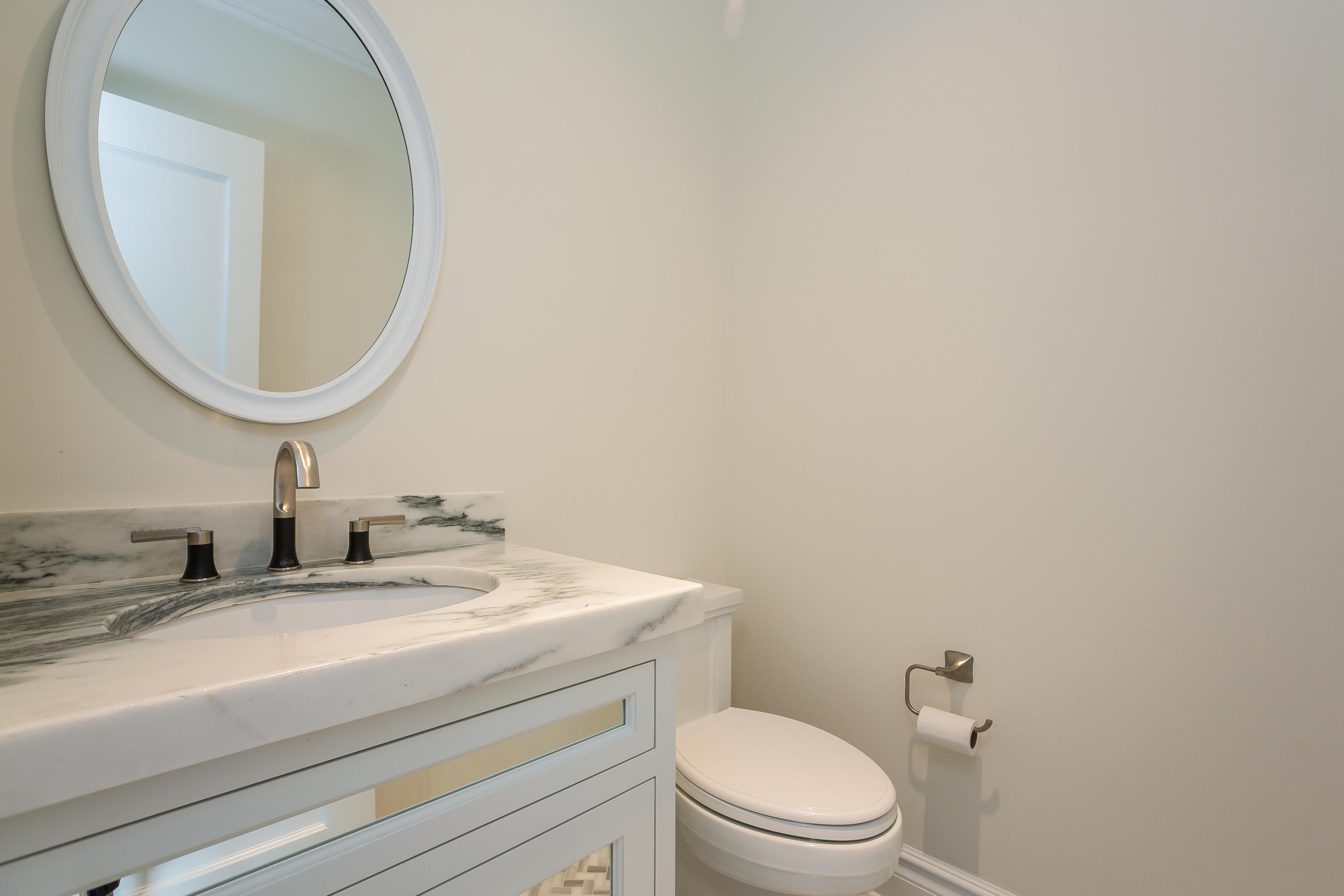 30 Albin Road Stamford, CT 06902 - Photo 17 of 38 a bathroom with a granite countertop toilet a sink and mirror