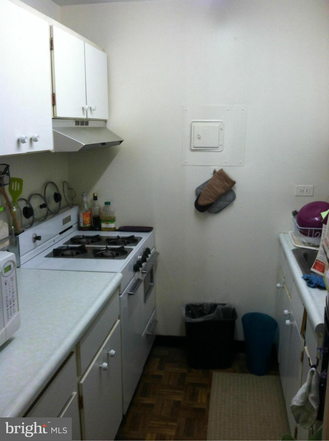 2201 L Street Northwest, Unit 820 Washington, DC 20037 - Photo 10 of 12 a kitchen with a sink and cabinets