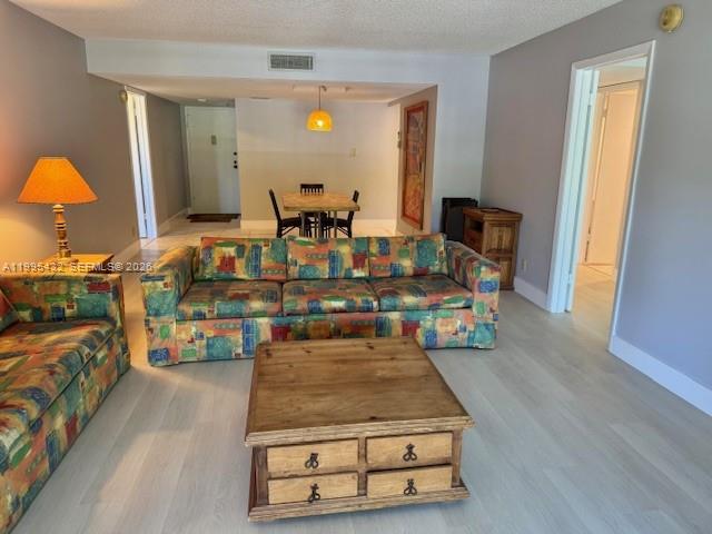 16300 Golf Club Road, Unit 208 Weston, FL 33326 - Photo 3 of 24 a living room with furniture and a table