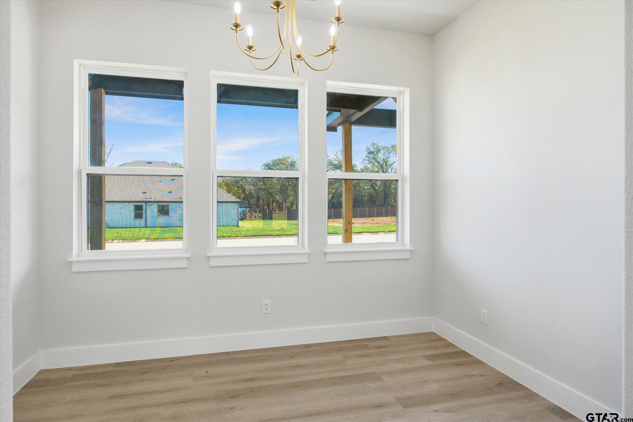 340 Dalton Road Canton, TX 75103 - Photo 12 of 31 an empty room with wooden floor and windows