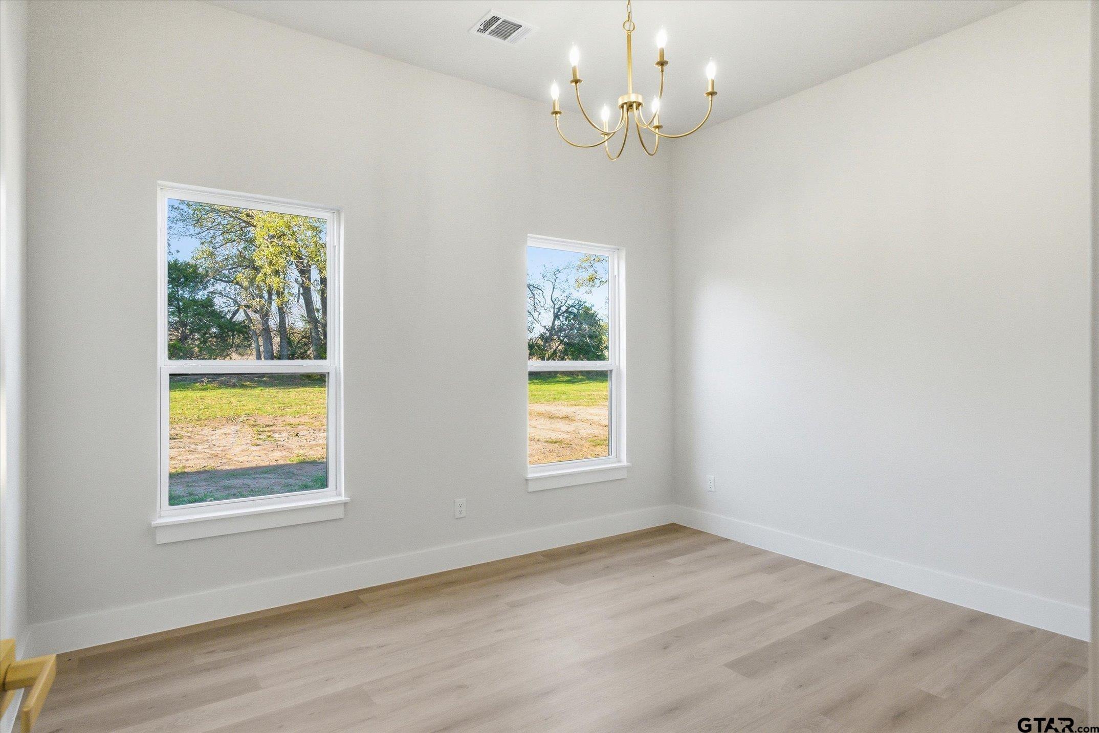 340 Dalton Road Canton, TX 75103 - Photo 22 of 31 an empty room with a window and wooden floor