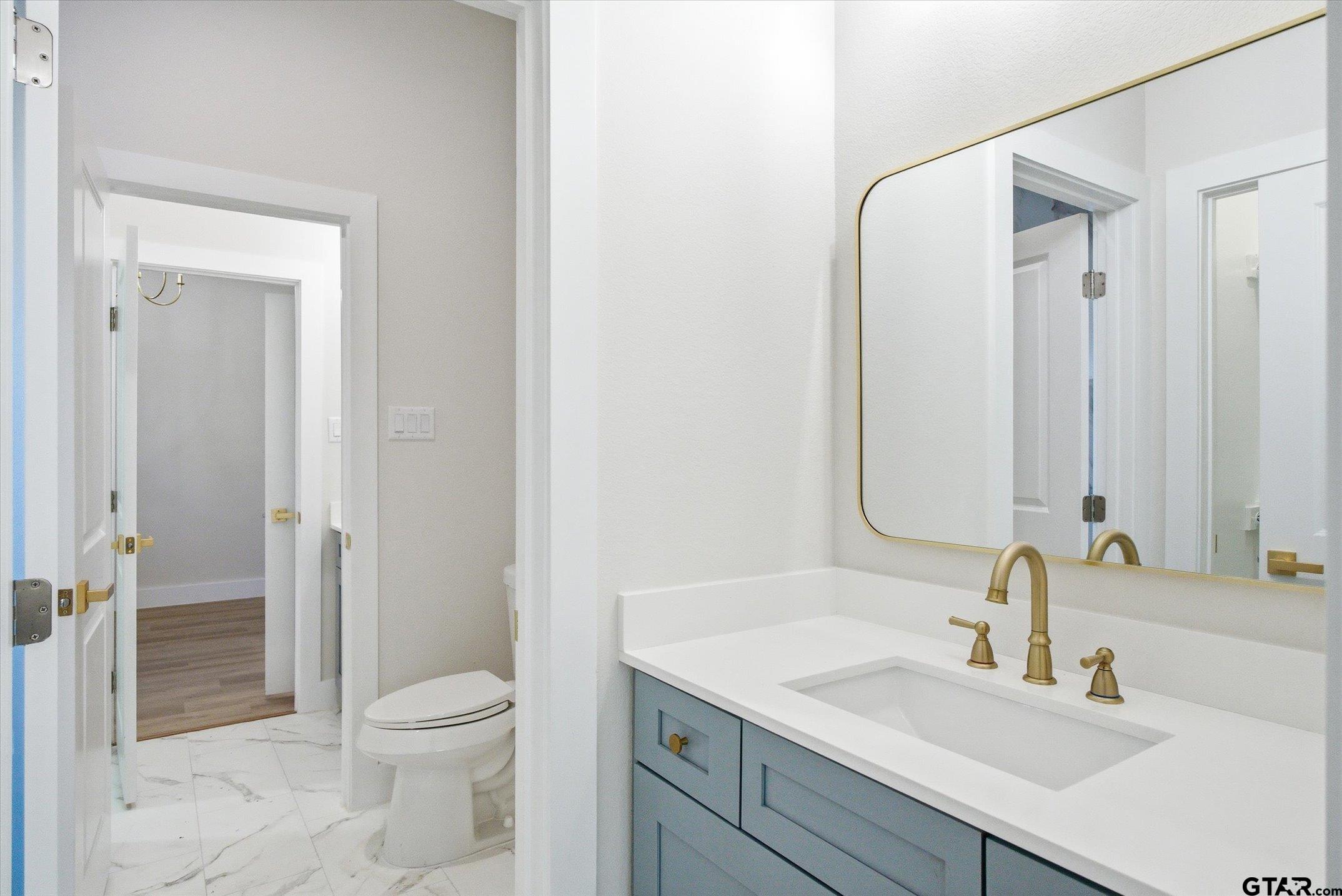 340 Dalton Road Canton, TX 75103 - Photo 25 of 31 a bathroom with a granite countertop sink a toilet and shower