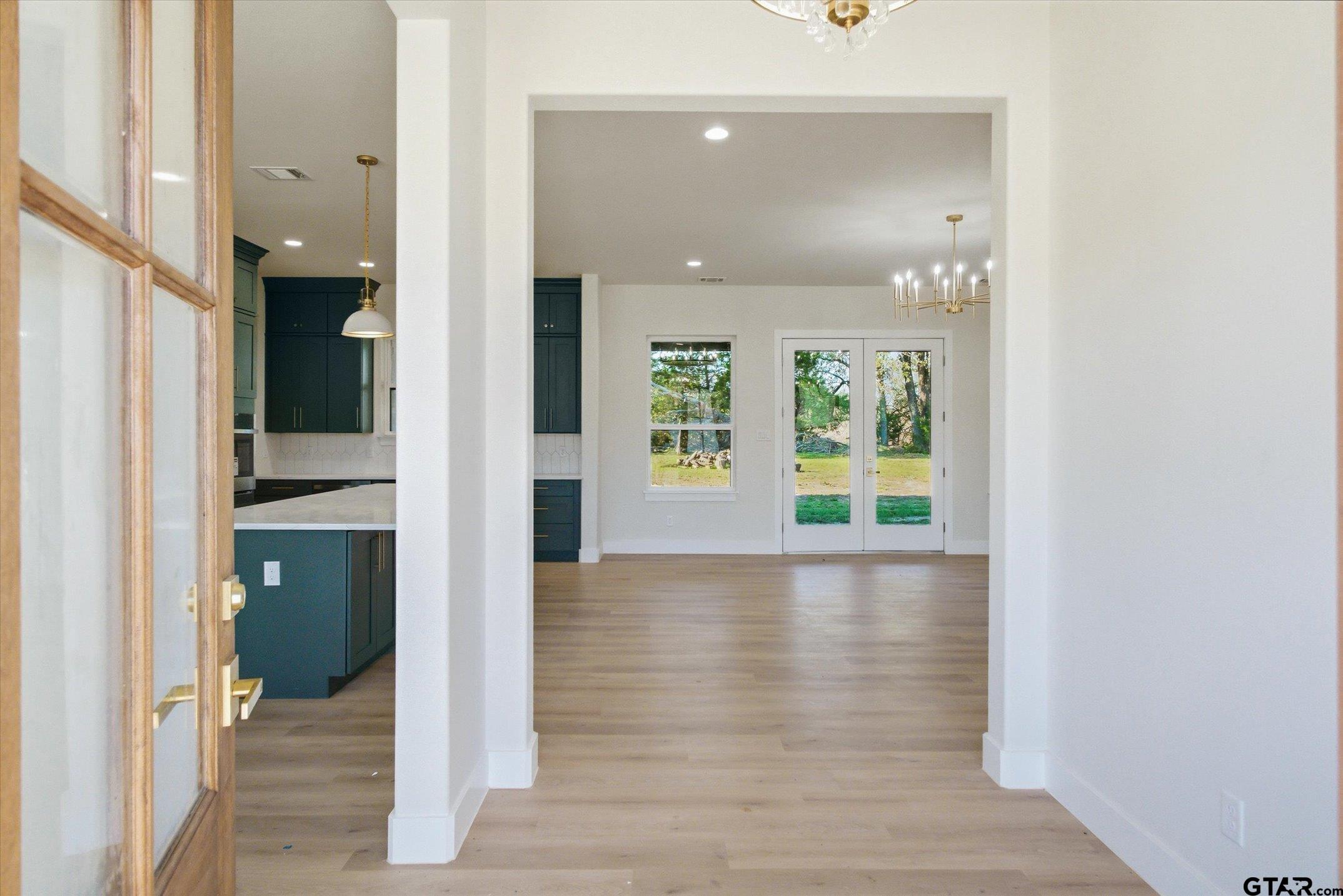 340 Dalton Road Canton, TX 75103 - Photo 3 of 31 a view of a hallway with wooden floor and a bathroom