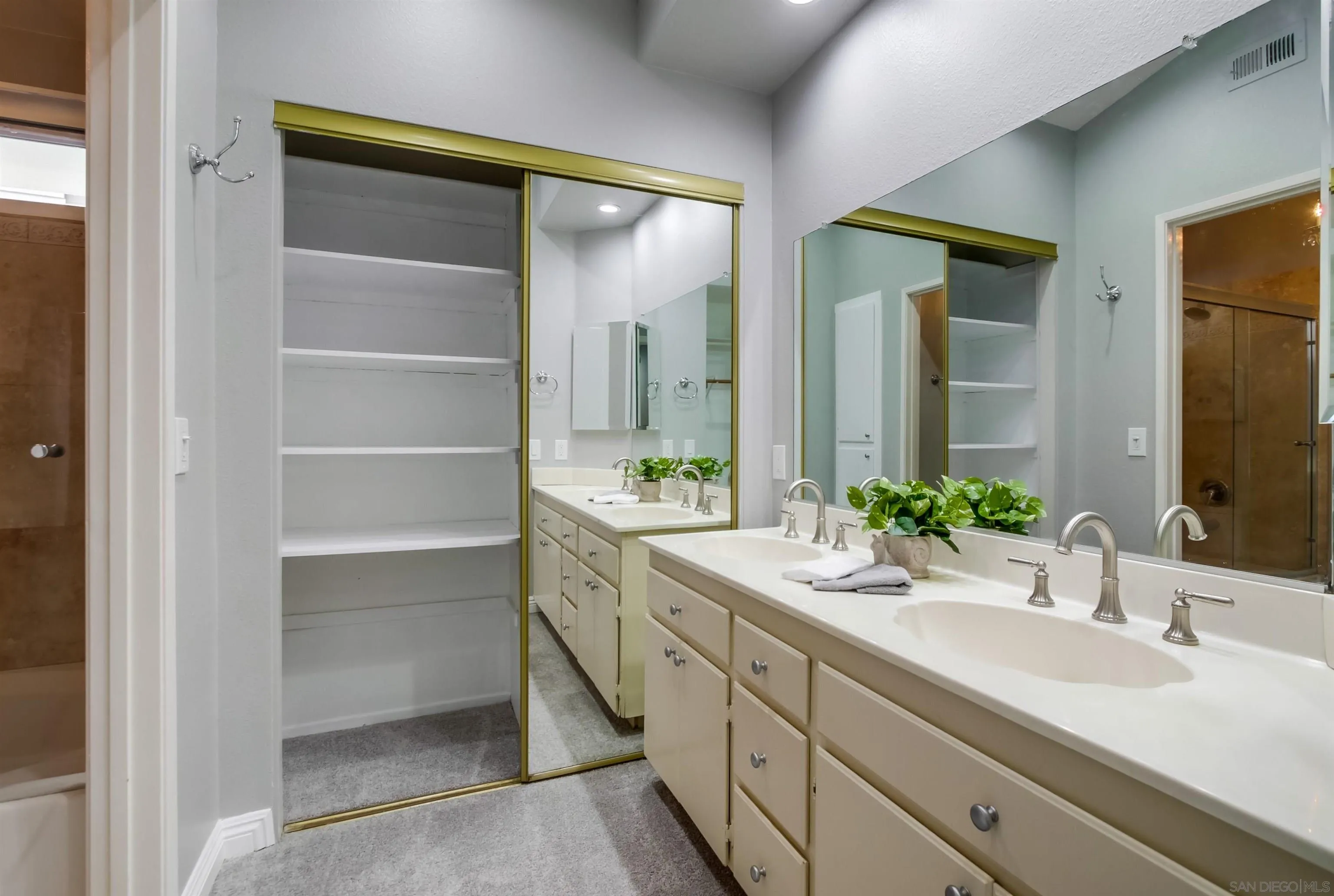 14150 Carmel Ridge Road San Diego, CA 92128 - Photo 12 of 21 a bathroom with a double vanity sink mirror and next