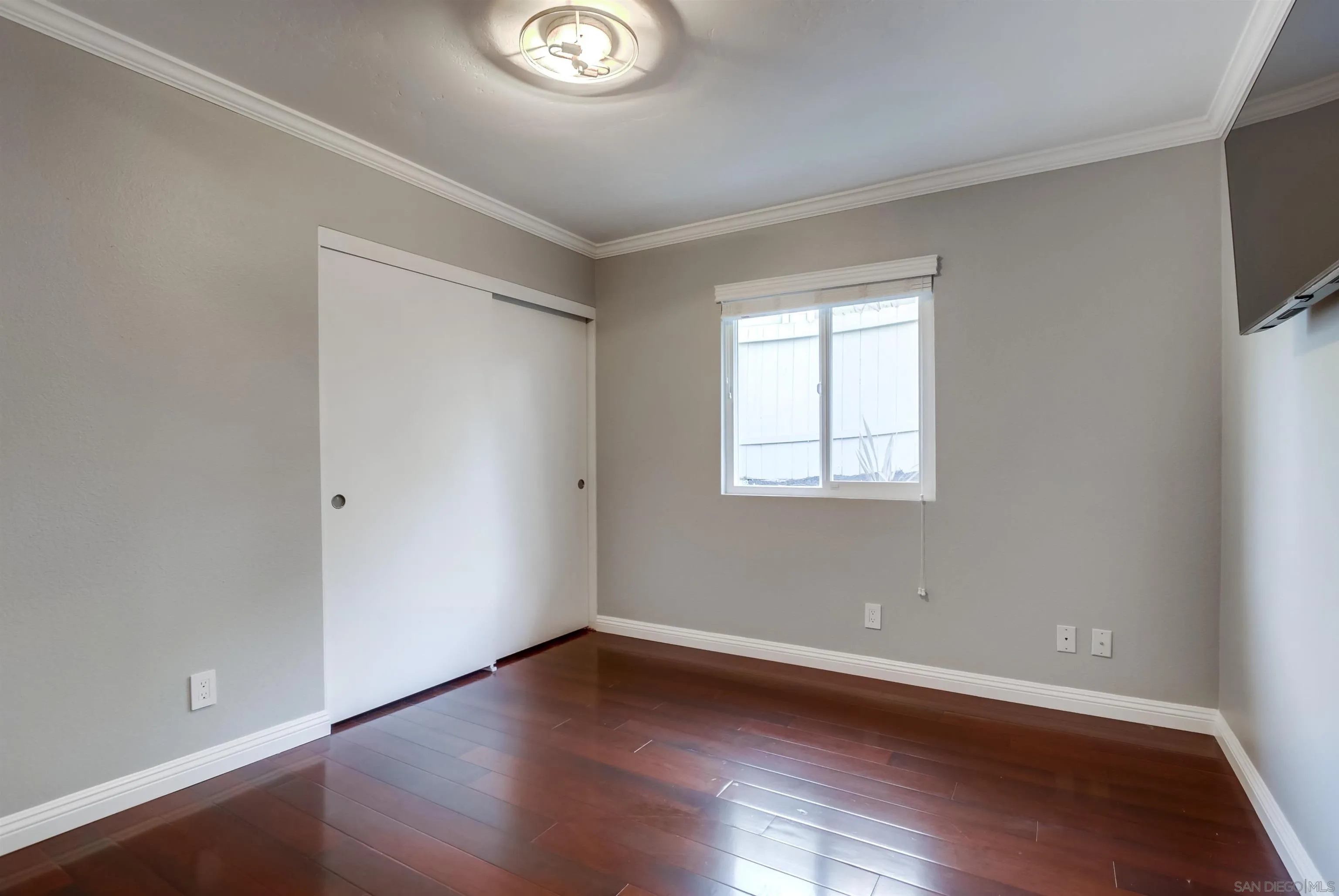 14150 Carmel Ridge Road San Diego, CA 92128 - Photo 14 of 21 a view of an empty room with wooden floor and a window