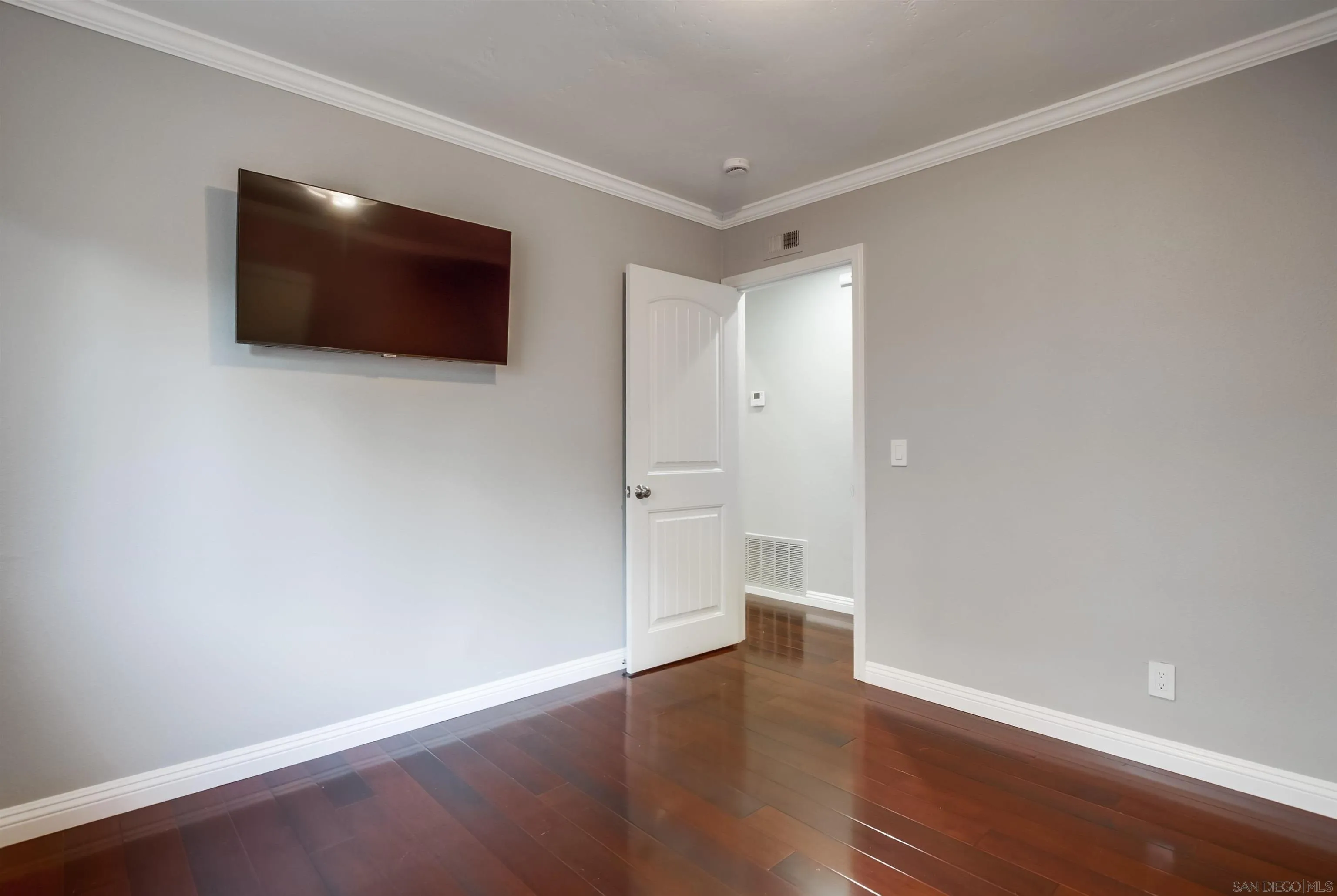 14150 Carmel Ridge Road San Diego, CA 92128 - Photo 15 of 21 a view of an empty room with wooden floor and a window