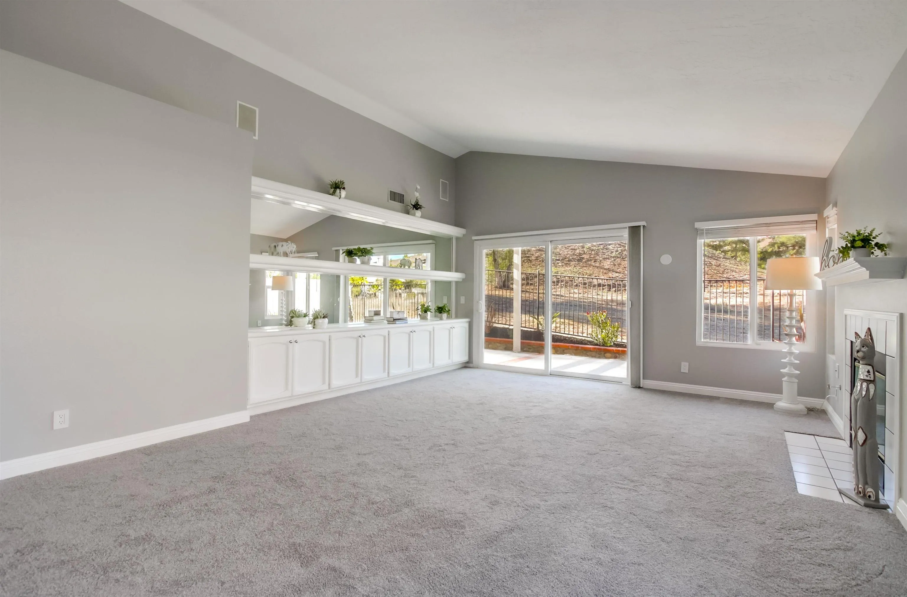 14150 Carmel Ridge Road San Diego, CA 92128 - Photo 4 of 21 a view of an empty room with a fireplace and a large window
