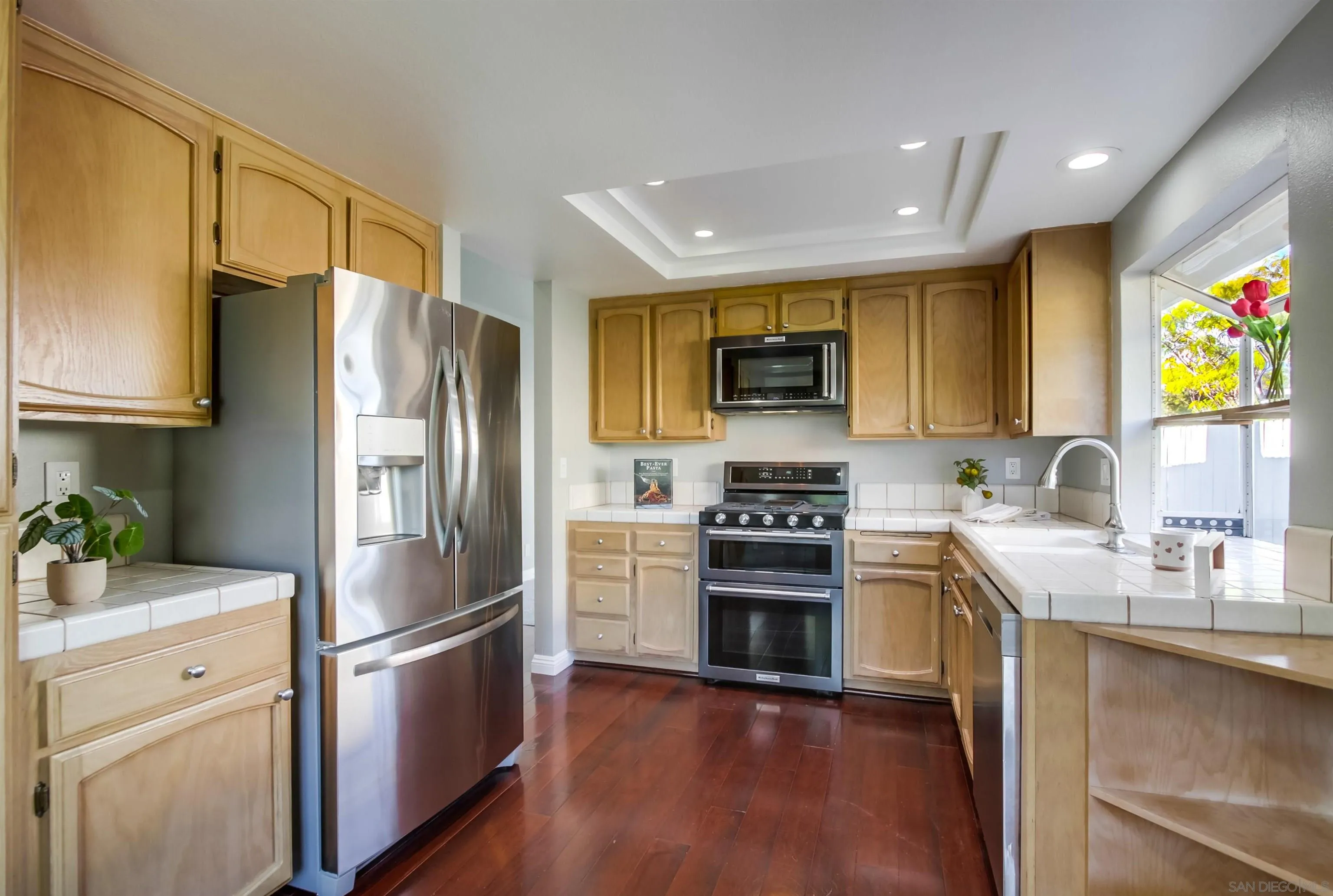 14150 Carmel Ridge Road San Diego, CA 92128 - Photo 7 of 21 a kitchen with stainless steel appliances a refrigerator stove microwave and sink