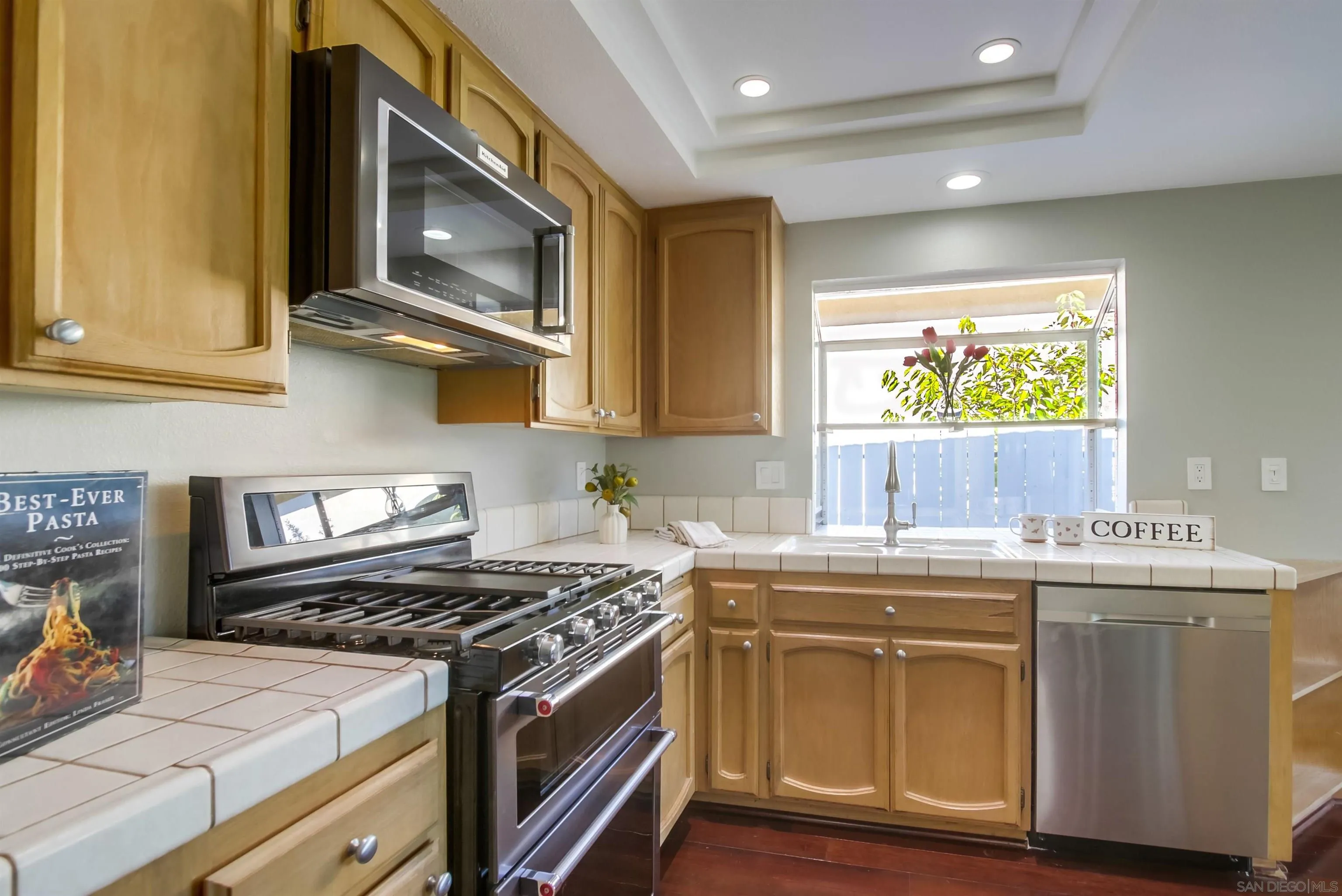14150 Carmel Ridge Road San Diego, CA 92128 - Photo 8 of 21 a kitchen with stainless steel appliances a stove a sink and a microwave