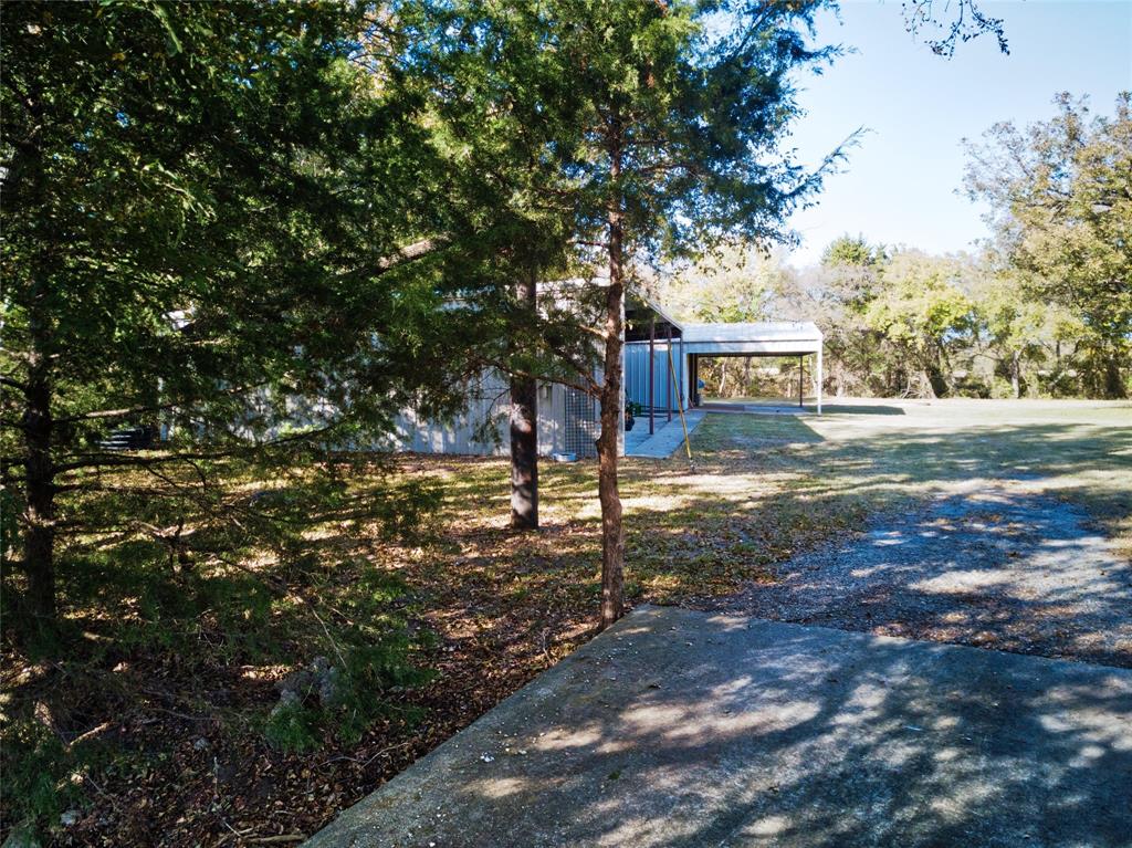 956 County Road 4231 Bonham, TX 75418 - Photo 17 of 25 a view of a street with a tree